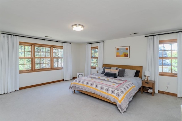 bedroom with baseboards, carpet, and visible vents