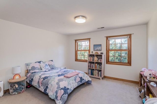 bedroom with visible vents, carpet flooring, and baseboards
