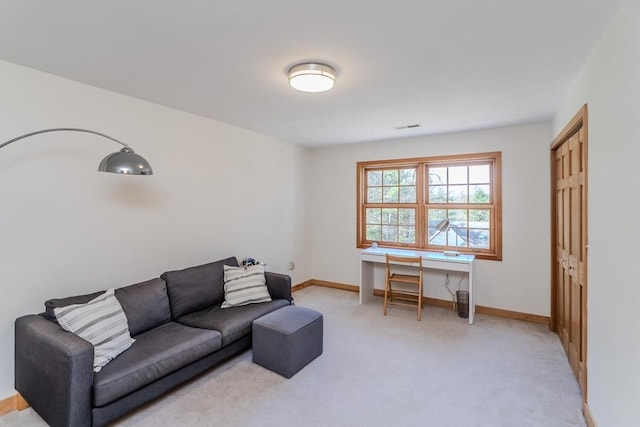 living area with baseboards, light carpet, and visible vents