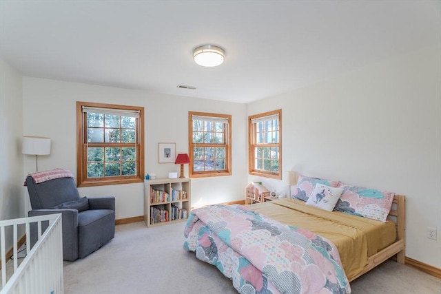 carpeted bedroom featuring visible vents and baseboards