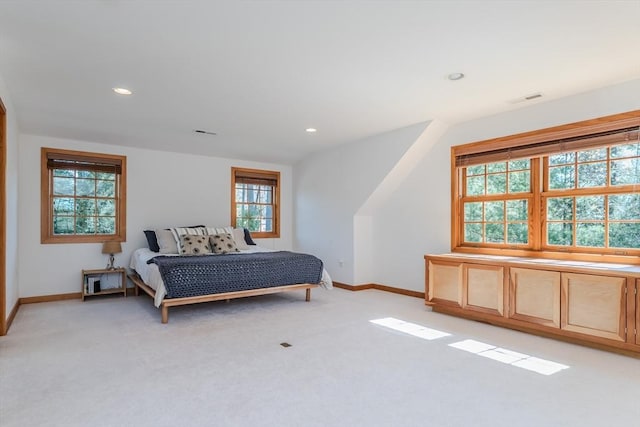 bedroom featuring baseboards, light carpet, recessed lighting, and visible vents