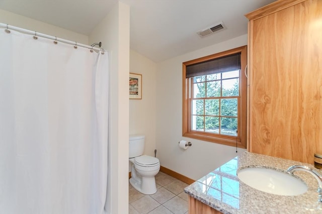 bathroom with visible vents, tile patterned flooring, baseboards, vanity, and toilet