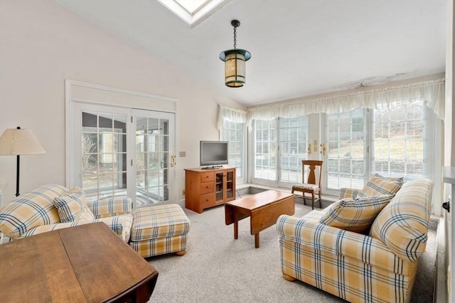 living area featuring lofted ceiling and light colored carpet