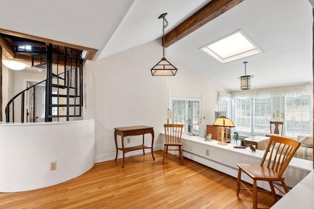 sitting room featuring stairs, vaulted ceiling with skylight, wood finished floors, and baseboards
