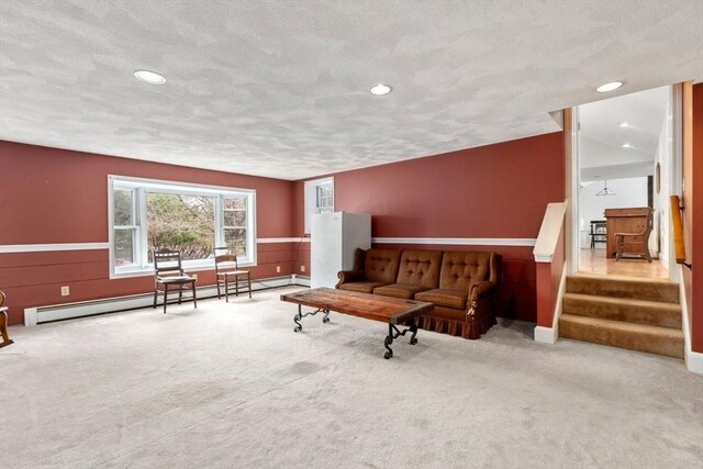 living room featuring wainscoting, carpet, and baseboard heating