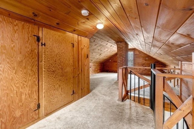 bonus room with wooden ceiling, wood walls, carpet, and lofted ceiling