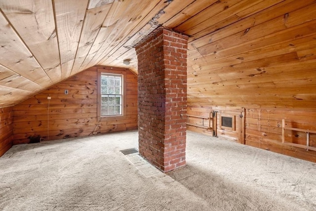 bonus room featuring lofted ceiling, wooden ceiling, wood walls, and carpet flooring