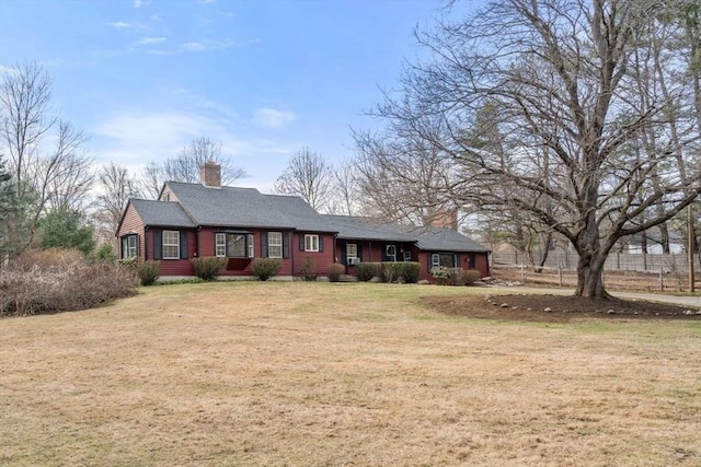 view of front of property with a chimney and a front yard