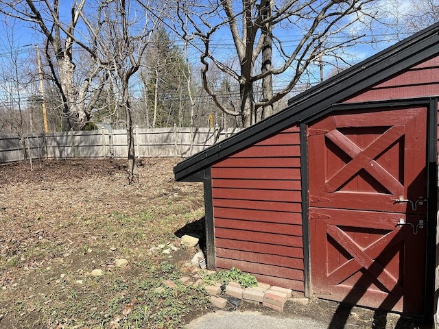 view of outbuilding with an outbuilding and fence