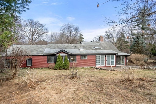 rear view of house with a chimney