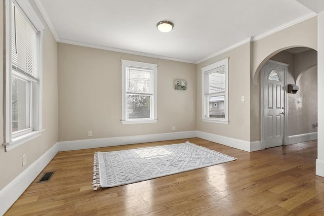 28 Mason, Salem, MA 01970 - empty room with arched walkways, wood finished floors, baseboards, and crown molding