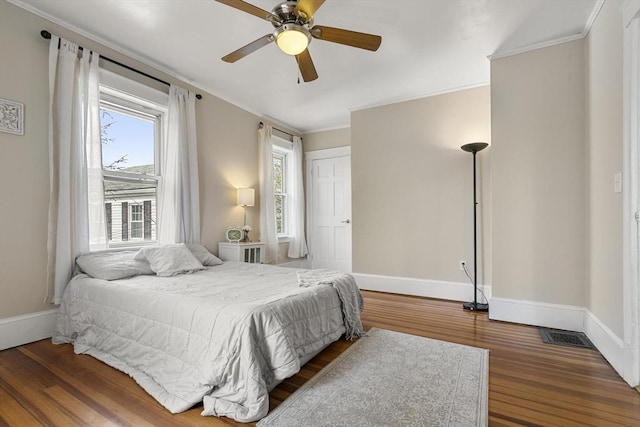 28 Mason, Salem, MA 01970 - bedroom with multiple windows, wood finished floors, baseboards, ornamental molding, and ceiling fan