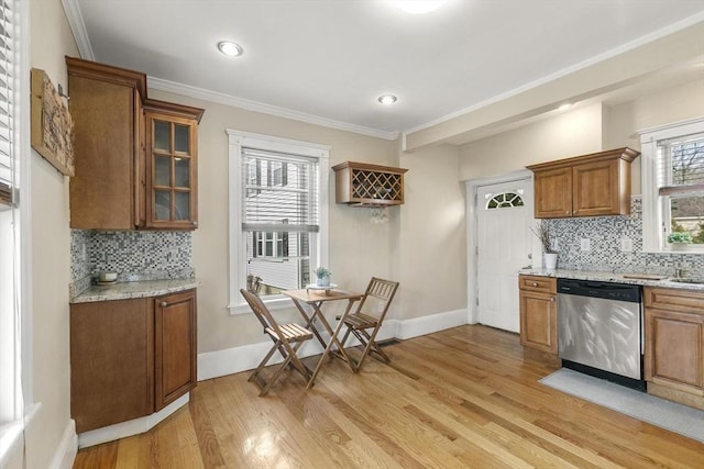 28 Mason, Salem, MA 01970 - kitchen with dishwasher, brown cabinets, light wood-style flooring, backsplash, and ornamental molding