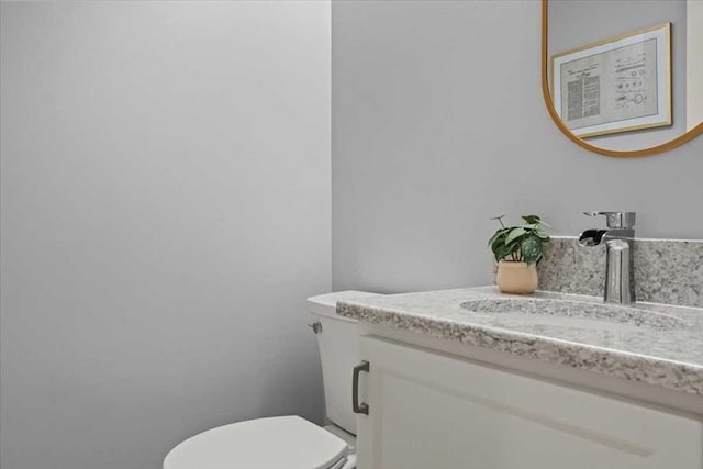 bathroom featuring toilet and vanity