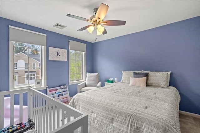bedroom with baseboards, ceiling fan, and carpet flooring