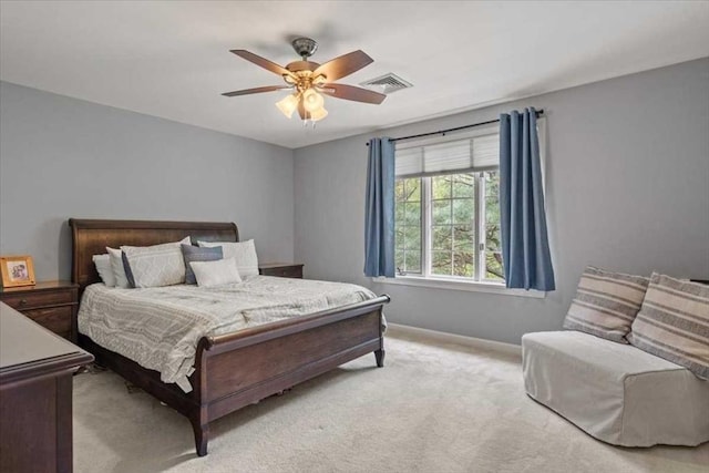 bedroom featuring light carpet, baseboards, and a ceiling fan