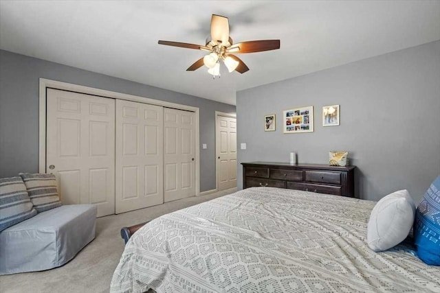 carpeted bedroom featuring a closet and a ceiling fan