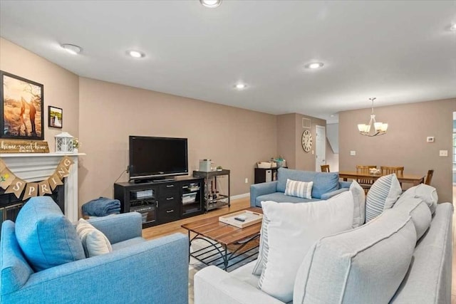 living area with a chandelier, wood finished floors, and recessed lighting
