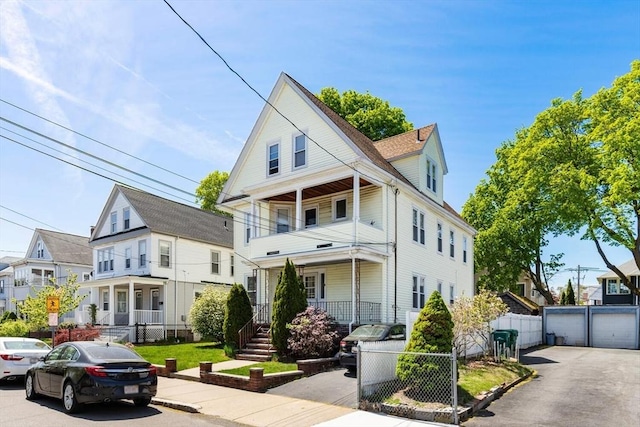 124 Grant Ave, Medford, MA 02155 - traditional style home with a porch, fence, a gate, and a balcony