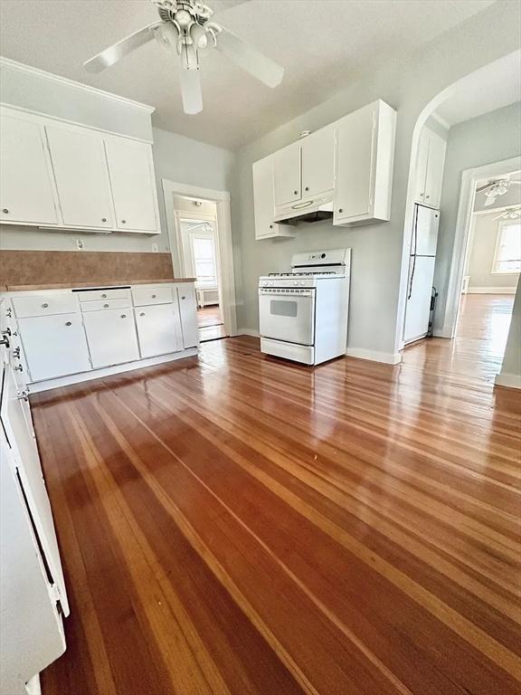 124 Grant Ave, Medford, MA 02155 - kitchen featuring white appliances, under cabinet range hood, white cabinets, and ceiling fan