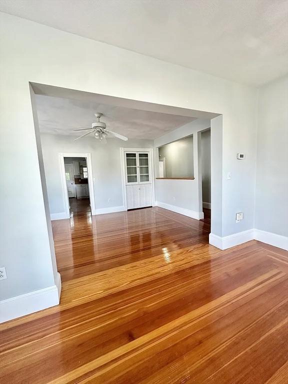 124 Grant Ave, Medford, MA 02155 - spare room with wood finished floors, a ceiling fan, and baseboards
