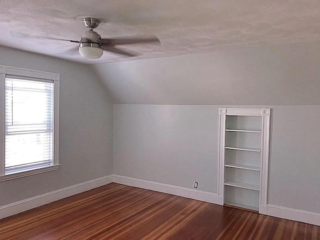 124 Grant Ave, Medford, MA 02155 - additional living space with vaulted ceiling, baseboards, wood finished floors, a ceiling fan, and a textured ceiling