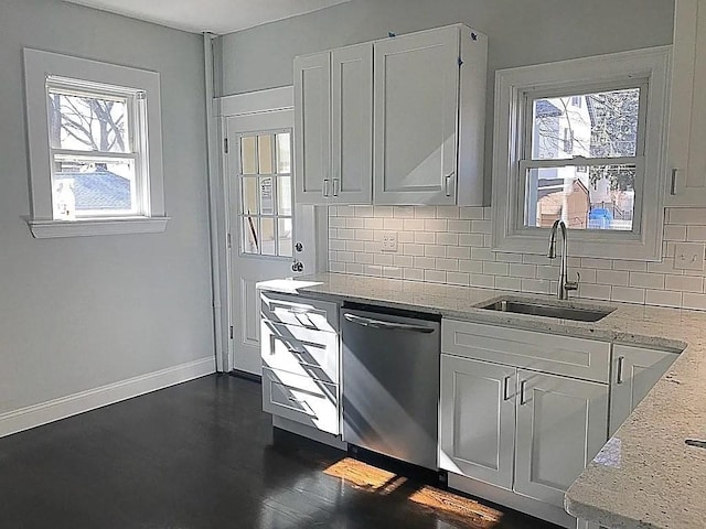124 Grant Ave, Medford, MA 02155 - kitchen with a sink, stainless steel dishwasher, tasteful backsplash, light stone counters, and baseboards