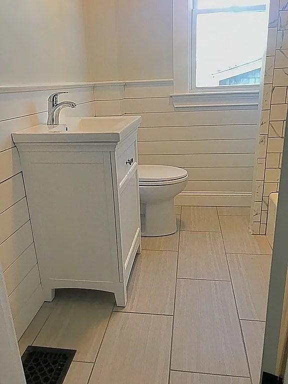 124 Grant Ave, Medford, MA 02155 - bathroom with toilet, vanity, and tile walls