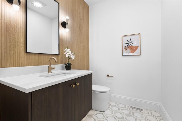 bathroom featuring toilet and vanity