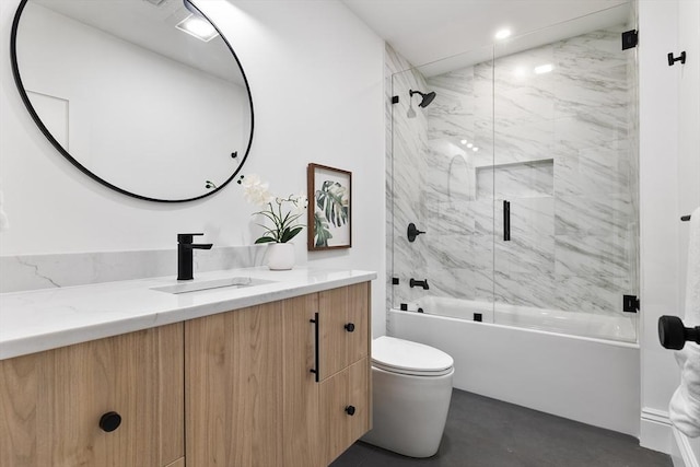 full bathroom featuring enclosed tub / shower combo, vanity, and toilet