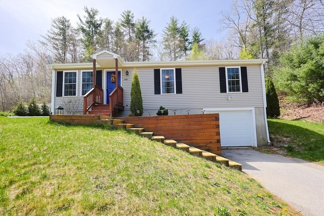 view of front of property with an attached garage, driveway, and a front yard