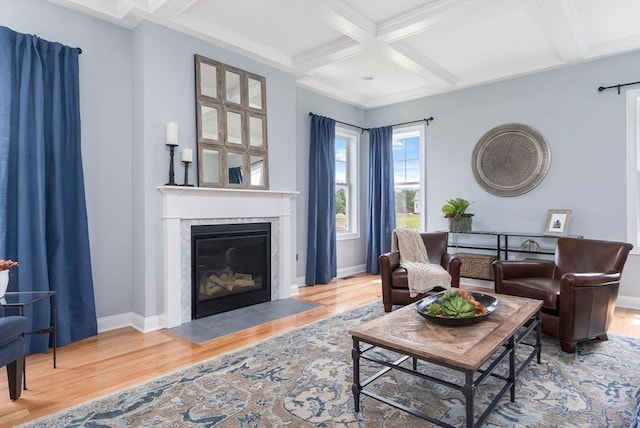 living room featuring coffered ceiling, hardwood / wood-style floors, and beamed ceiling