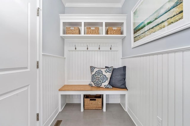 mudroom with light tile patterned floors and ornamental molding