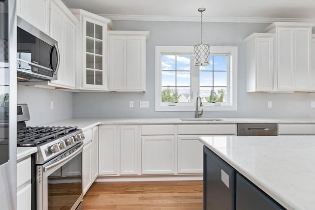 kitchen with white cabinetry, appliances with stainless steel finishes, and sink