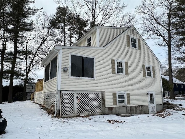 view of snow covered rear of property