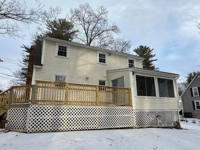 snow covered house with a deck