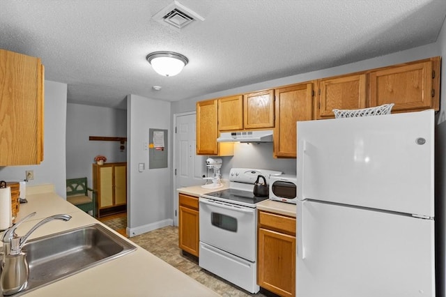 181 Littleton Rd Unit 333, Chelmsford, MA 01824 - kitchen with white appliances, under cabinet range hood, a sink, light countertops, and a textured ceiling