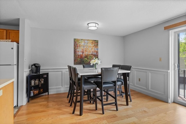 181 Littleton Rd Unit 333, Chelmsford, MA 01824 - dining room with a decorative wall, light wood finished floors, wainscoting, and a textured ceiling