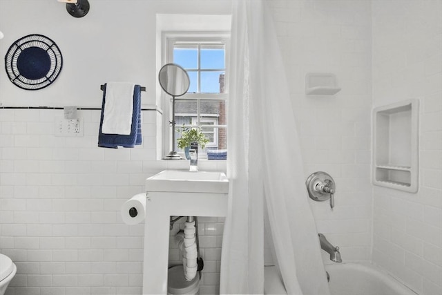 full bathroom featuring tile walls, shower / bathtub combination with curtain, and toilet
