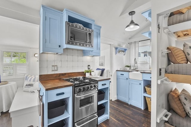 kitchen featuring open shelves, stainless steel appliances, butcher block countertops, blue cabinets, and vaulted ceiling