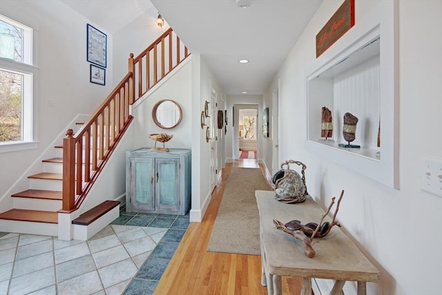 corridor featuring plenty of natural light and hardwood / wood-style floors