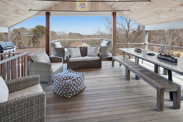 wooden terrace with an outdoor living space