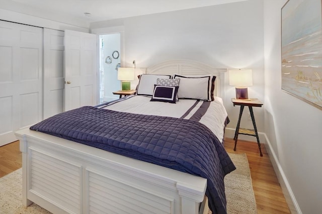 bedroom featuring light hardwood / wood-style floors and a closet