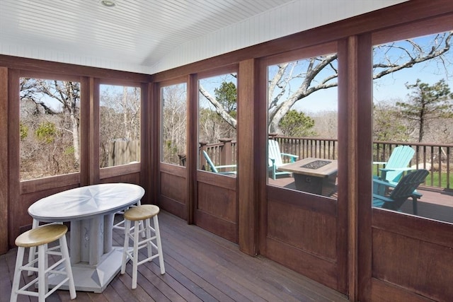 sunroom featuring vaulted ceiling