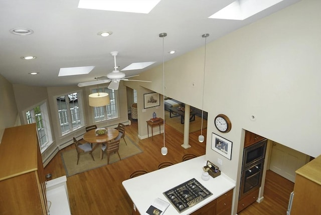 1074 Concord Rd, Sudbury, MA 01776 - kitchen with a skylight, wood finished floors, stainless steel microwave, oven, and recessed lighting