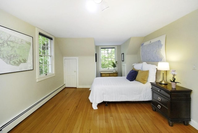 1074 Concord Rd, Sudbury, MA 01776 - bedroom featuring baseboard heating, hardwood / wood-style flooring, and baseboards