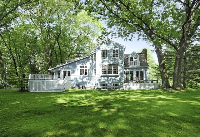 1074 Concord Rd, Sudbury, MA 01776 - rear view of house with a wooden deck, a yard, a chimney, and stairs