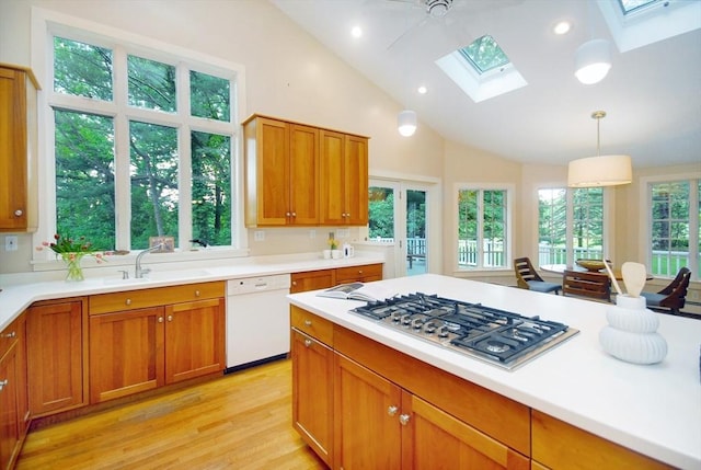 1074 Concord Rd, Sudbury, MA 01776 - kitchen with a skylight, stainless steel gas stovetop, white dishwasher, light wood-type flooring, and a sink
