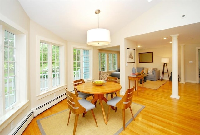 1074 Concord Rd, Sudbury, MA 01776 - dining space with ornate columns, lofted ceiling, light wood-type flooring, and a baseboard radiator