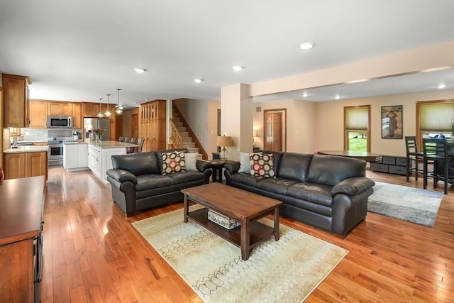 16 Blueberry Way, Webster, MA 01570 - living area with stairway, light wood finished floors, and recessed lighting